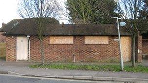 The toilet with boards covering its windows