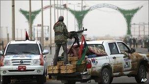 Libyan rebel fighters riding pick-up trucks by the western gate of Ajdabiya, Libya, 15 April 2011