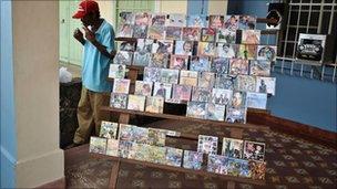 A self-employed Cuban man selling DVDs waits for customers on April 15, 2011 in Caimito, Mayabeque province