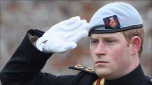 Prince Harry saluting at a memorial