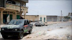 Rebel fighters attack a position occupied by government snipers in Misrata, Libya, 16 April 2011