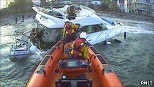 Lifeboat helping sinking motorboat