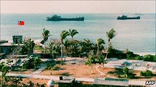 File photo shows two Taiwanese warships docking near Taiping Island, one of the disputed Spratly Island chain, with the Taiping military base in the foreground