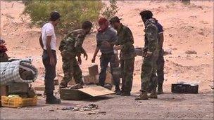 Libyan rebels unpack landmines before laying them near Ajdabiya, 17 April