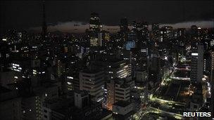 Lights are turned off to save energy before rolling blackouts in Tokyo