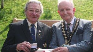 Les Jones (left) receiving an award from Powys council chairman Garry Banks last year for his fundraising work