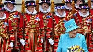 Queen Elizabeth walks past Yeomen of the Guard as she leaves a Maundy Service, on her 85th birthday, at Westminster Abbey