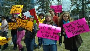 Canadian students holding political signs