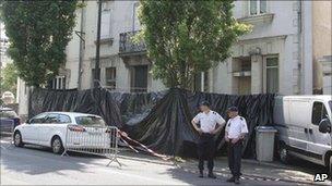 Police stand outside the house in Nantes where the family were living, 21 April