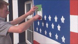 Putting the finishing touches to a mural of the American flag