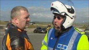 North Wales Police bike patrol officer speaks to motorcyclist