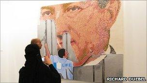 A picture depicting Egypt's Hosni Mubarak being torn down