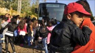 Roma women and children leave Gyongyospata, Hungary (22 April 2011)