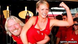 Sir Richard Branson and woman at the launch of a Virgin Active gym in Australia