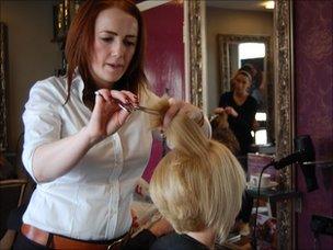 Hairdresser Abbie Jackson cuts a client's hair