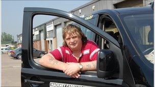 Dave Williams stands in front of his black cab