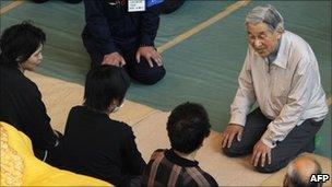 Japan's Emperor Akihito talks to people in a shelter in Minamisanriku on 27 April 2011