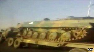 A video grab reportedly showing an army lorry transporting a tank near the flashpoint town of Deraa, Syria, 27 April 2011