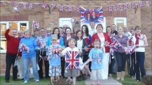 People in Lilac Drive, Monmouth, waving flags outside a house with bunting