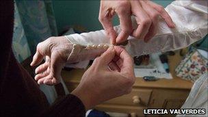 Buttoning up a wedding dress