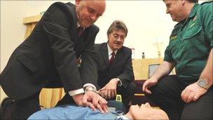 Two men practicing CPR on a dummy