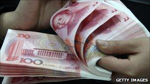 Bank staff deals with Chinese currency