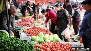 People shop for food in a fresh food market in east China.