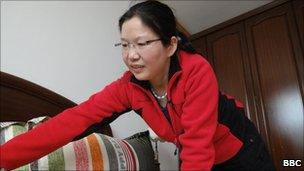 Migrant worker Xie Shuxiang cleans a flat in Shanghai.