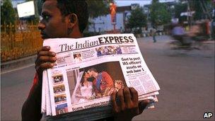 A vendor brings news of the wedding to the people of Allahabad, India