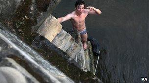 A student emerging from a swim in the River Thames off Magdalen Bridge