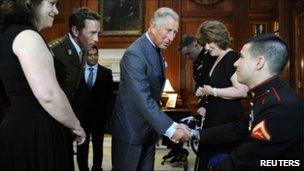 Prince Charles greets amputee during US visit