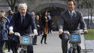 Boris Johnson and Arnold Schwarzenegger riding bikes.