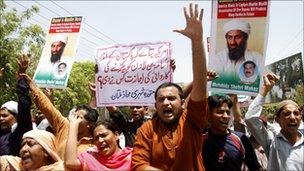 Demonstrators hold posters of al Qaeda leader Osama bin Laden, who was killed on Monday in a U.S. special forces assault on a Pakistani compound, as they chant anti-U.S. slogans during a rally of more than 100 people in Multan May 4, 2011.