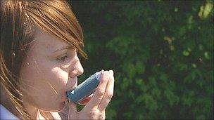 Asthma sufferer using inhaler