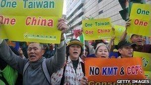 Anti-China demonstrators hold placards during a rally outside a hotel in Taipei.