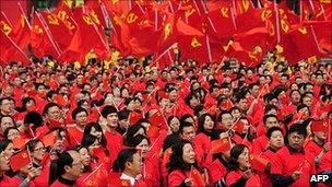 Members and their families gather for a rally celebrating the forthcoming 90th anniversary of the Chinese Communist Party