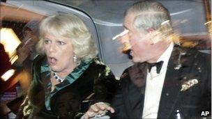 Prince Charles and Camilla, Duchess of Cornwall react as their car is attacked during the student protests