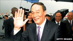 Chinese Vice-Premier Wang Qishan waves to reporters in Nairobi