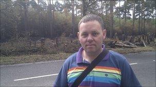 Kelly Hutchinson in Brookers Row with burned forest behind him