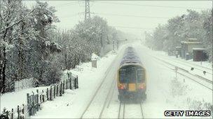 A train runs through the snow in Winchfield, Hampshire