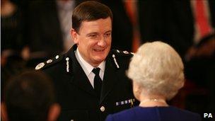 Mr Maxwell receiving the Queen's Police Medal