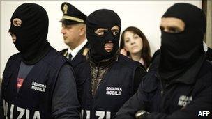 Italian policemen attend a press conference after a mafia leader's arrest on 2 May 2011