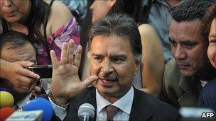 Alfonso Portillo waves to his supporters outside the court in Guatemala City