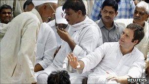 Rahul Gandhi gestures to a villager during his visit to Parsaul village on 11 May 2011