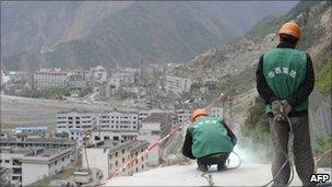 Construction workers build a viewing platform above a quake-hit town in Sichuan on 19 April 2011