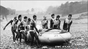 Staff and students carry an inflatable boat (Copyright: UWC Atlantic College)