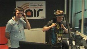 Two boys listening to radio