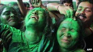 Trinamool Congress party supporters celebrate outside the residence of party leader Mamata Banerjee in Calcutta, on May 13, 2011.