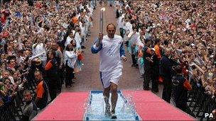 Sir Steve Redgrave carrying the Olympic torch along Pall Mall in 2008