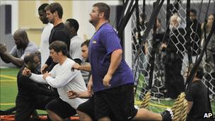 Detroit Lions players work out in a school in Michigan on Monday